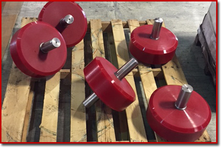 Red polyurethane rollers on a pallet